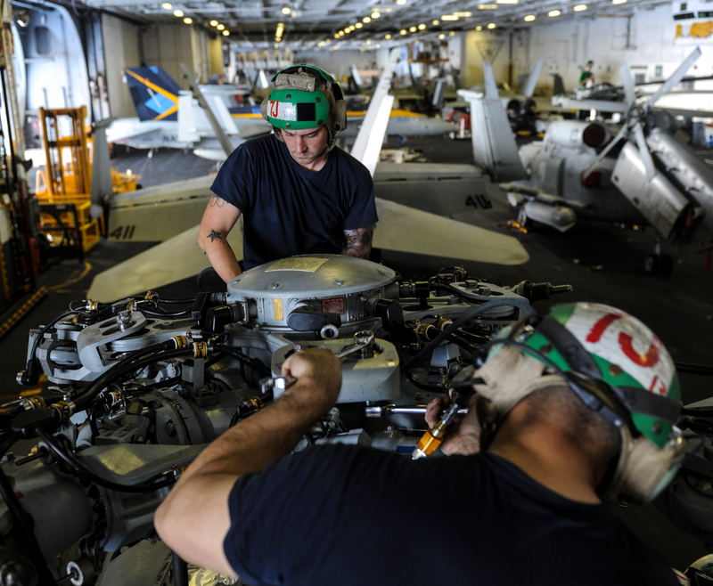 Working the rotor mast and attachments, the USN regularly disassembles aircraft at sea, both to keep current on technique and to check for corrosion. Navy aircraft are designed to be more resistant to the elements than land base planes but saltwater, movement of both the ship and the aircraft on it, and other factors require constant maintenance. It’s important to remember that on a ship/small city of 5,000 sailors only a tiny handful actually fly the planes... it’s sailors like this guy who make it all possible for the “hero” fighter jocks to safely fly their planes.